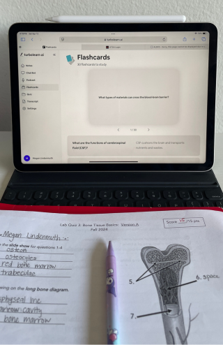 laptop with flashcards and open textbook