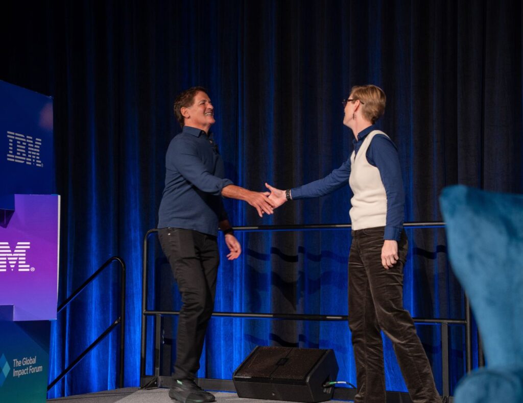 Mark Cuban and Charlotte Dungan shake hands at Global Impact Forum