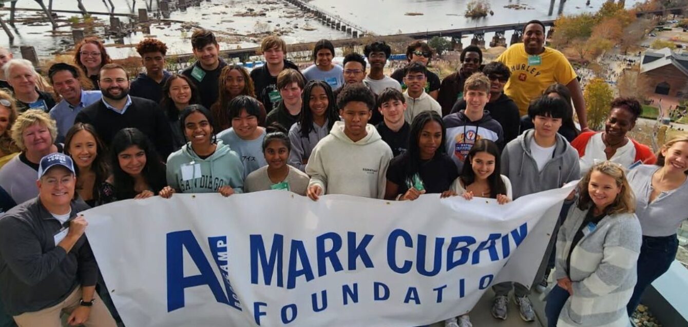 2025_ai_bootcamp_year_in_review Group photo of students, mentors, and volunteers at AI Bootcamp holding banner