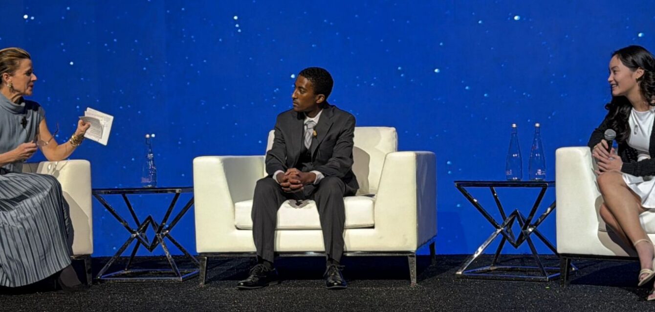 Kate Maloney, Adonias Tadesse, and Angeline Le onstage at Infosys gala