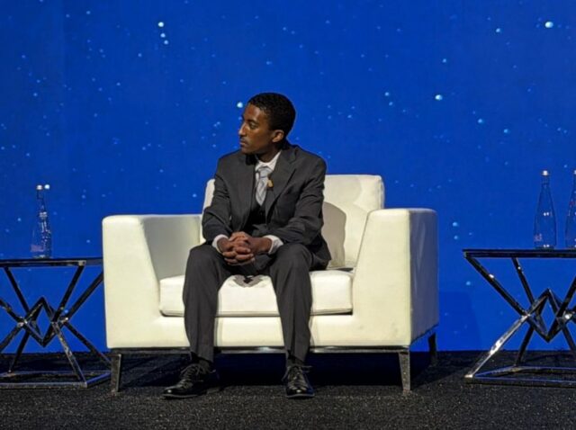 Kate Maloney, Adonias Tadesse, and Angeline Le onstage at Infosys gala