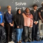 Charlotte Dungan, Chief Learning Officer at the Mark Cuban Foundation poses with students at Samsung Solve for Tomorrow event