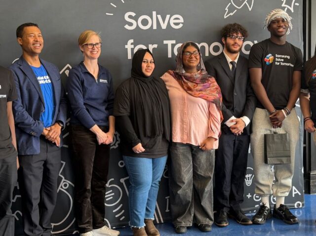 Charlotte Dungan, Chief Learning Officer at the Mark Cuban Foundation poses with students at Samsung Solve for Tomorrow event