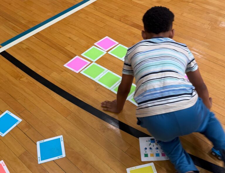 Student lining up tiles at Game of Drones